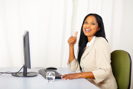 Portrait of a successful executive female at work while lift a finger up and laughing to youの写真素材
