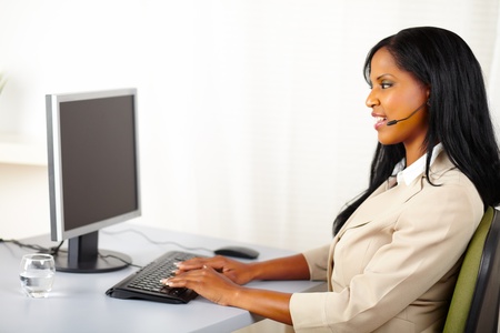 Portrait of a professional callcenter operator working on computerの写真素材