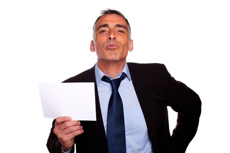Portrait of a friendly senior businessman holding a white card with copyspace while having fun on isolated backgroundの写真素材