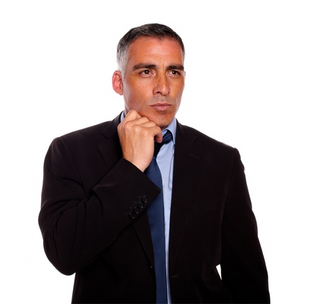 Portrait of a charismatic attractive man on black suit thinking against white backgroundの写真素材
