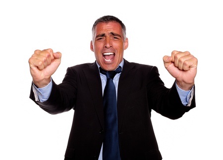 Portrait of a happy executive on black suit screaming and celebrating on isolated backgroundの写真素材