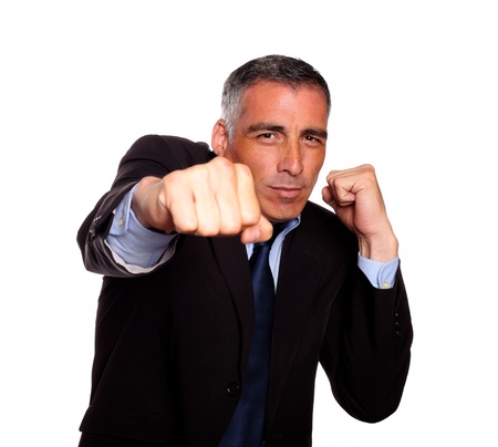 Portrait of a elegant business man on black suit boxing against white backgroundの写真素材