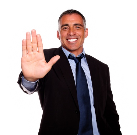 Portrait of a attractive and charming man giving the high on black and blue suit against white backgroundの写真素材