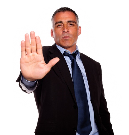 Portrait of a hispanic senior man giving the high on black suit against white backgroundの写真素材