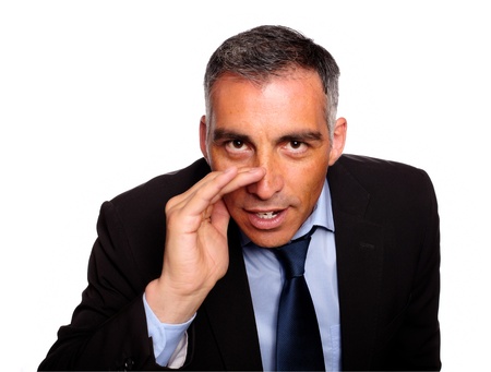 Portrait of a hispanic senior executive telling a confidence against white backgroundの写真素材