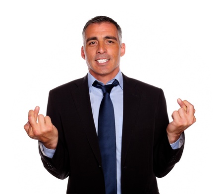 Portrait of a charming latin businessman crossing the fingers on isolated backgroundの写真素材