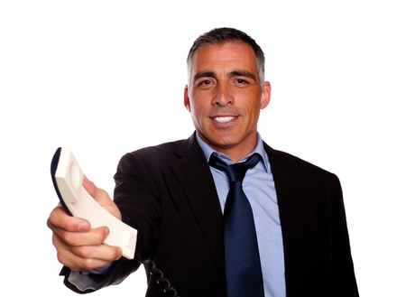 Portrait of a attractive and gorgeous man offering you make a call on black suit against white backgroundの写真素材