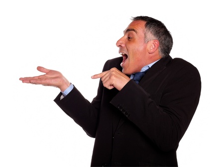 Portrait of a adult man looking and pointing extended right hand against white backgroundの写真素材