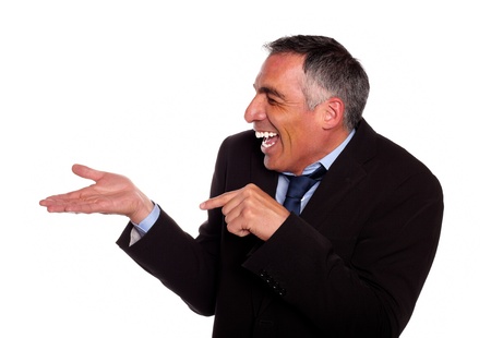 Portrait of a businessman laughing and pointing extended right hand on black and blue suit on isolated backgroundの写真素材