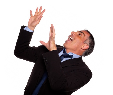 Portrait of a friendly hispanic businessman screaming while falling down against white backgroundの写真素材
