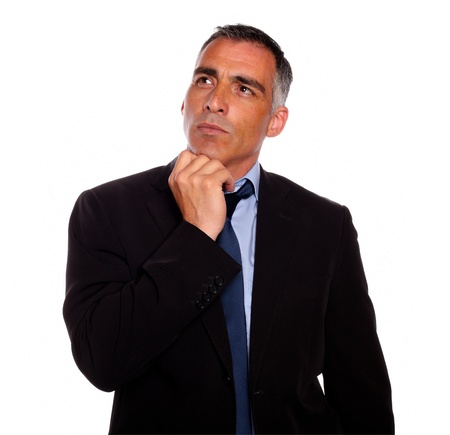 Portrait of a peaceful and reflective man touching the chin while thinking on black suit on isolated backgroundの写真素材