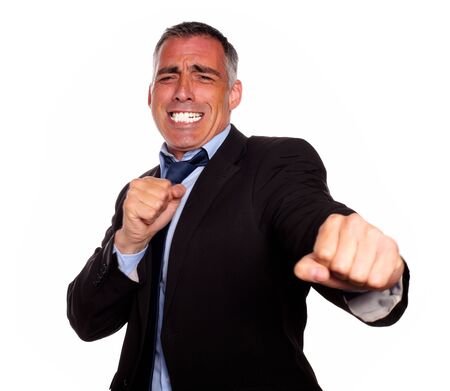 Portrait of a excited hispanic business man boxing on isolated backgroundの写真素材