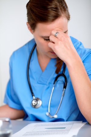 Portrait of a beautiful fatigue and tired doctor woman with a stethoscope at hospitalの写真素材