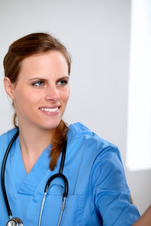 Portrait of a charming pretty doctor woman looking at a radiograph at hospitalの写真素材