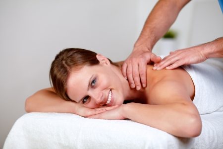 Portrait of a charming young blonde woman relaxing at a spa while receiving a massage at spa resort copyspaceの写真素材