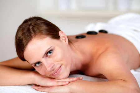 Close up portrait of a attractive young woman at a spaの写真素材