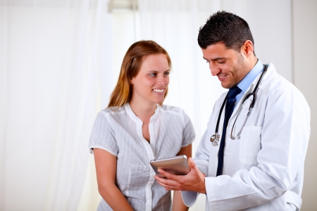 Portrait of a professional medical doctor with a patient at hospital indoorの写真素材