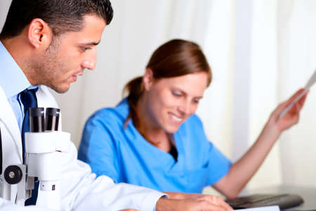 Portrait of two medical scientific working at laboratory at hospital indoorの写真素材