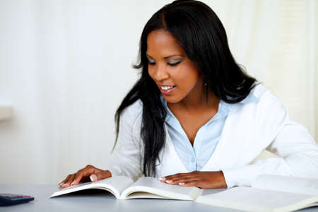Portrait of a beautiful black girl studying at soft colors compositionの写真素材