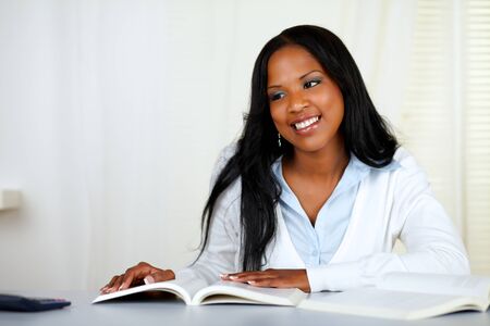 Portrait of a beautiful black woman studying at soft colors compositionの写真素材