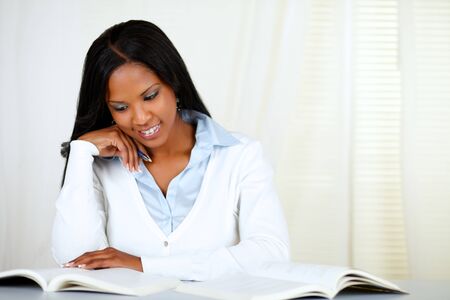 Portrait of an afro-american young black woman learning at soft colors compositionの写真素材