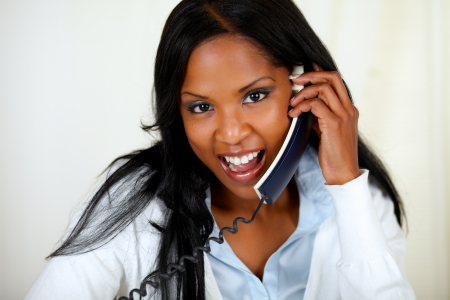 Close up portrait of a charming young woman speaking on phoneの写真素材