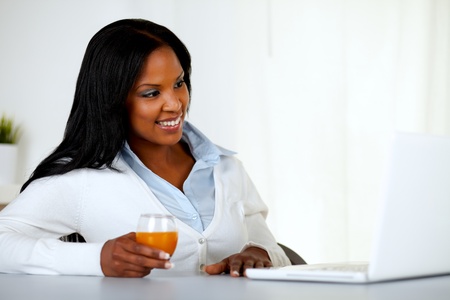 Portrait of a pretty young girl relaxing on laptop at soft colors compositionの写真素材