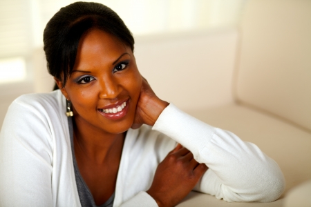 Portrait of a lovely relaxed girl smiling and looking at you at soft colors composition. With copyspaceの写真素材