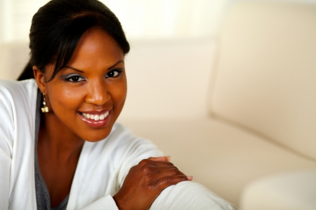 Portrait of a stylish black female looking at you at home indoor. With copyspaceの写真素材