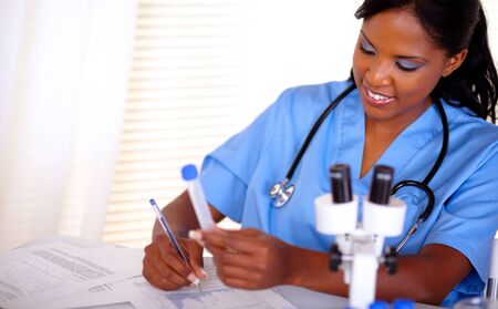 Afro-american nurse with a stethoscope in blue uniform working at laboratory - copyspaceの写真素材