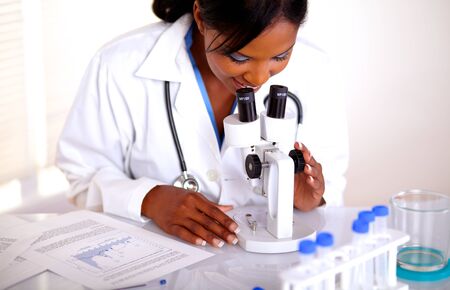 Medical doctor female working with a microscope at laboratoryの写真素材