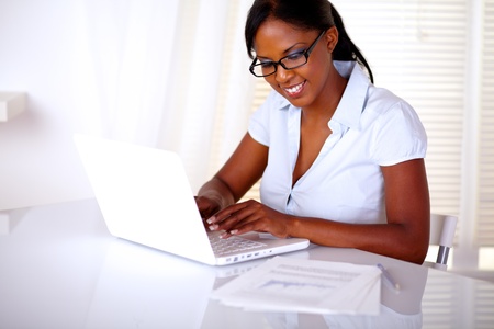 Afro-american woman using her laptop at workplaceの写真素材