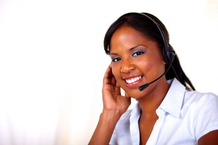 Attractive receptionist smiling and looking at you at callcenter - copyspaceの写真素材