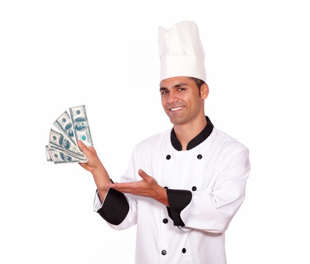 Portrait of a happy person in cook uniform holding cash money on white backgroundの写真素材