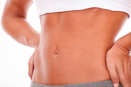 Female waist and hips with hands on hips facing front on a white backgroundの写真素材