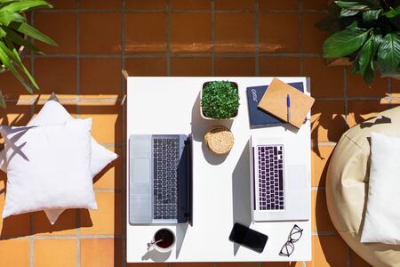 teleworking by a couple on the terrace of their houseの写真素材