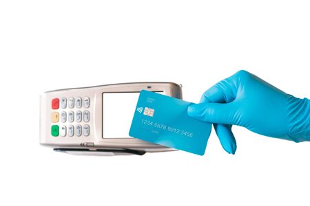 gloved hand swiping your credit card through the contactless payment terminal. Blank screen. White background.の写真素材