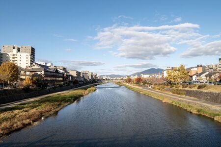 River view surrounded by some buildings and with a but cloudy sky.の写真素材