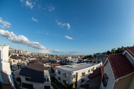 View of a Japanese neighborhood with many buildings and houses in a sunny day during afternoon (Toyonaka, Osaka, Japan) (20221203-019)の写真素材