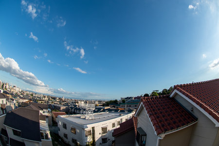 View of a Japanese neighborhood with many buildings and houses in a sunny day during afternoon (Toyonaka, Osaka, Japan) (20221203-018)の写真素材