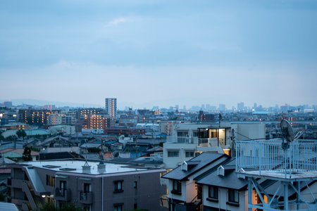 View of a Japanese neighborhood with many buildings and houses in a cloudy day during afternoon (Toyonaka, Osaka, Japan) (20221203-017)の写真素材