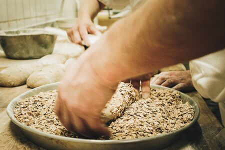 Prepare grain rolls in a bakeryの写真素材