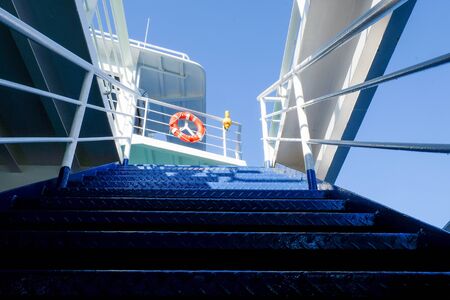 Shadow play on the metal stairs of a ship