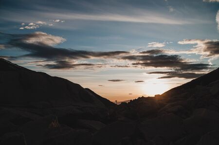 Cloudy sunset in a mountainous regionの写真素材
