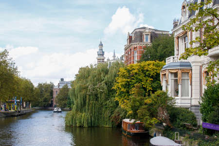 City view with historical houses and famous canal full of plantsの写真素材