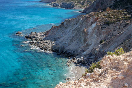 the rugged white and orange cliffs of the greek island of milosの写真素材