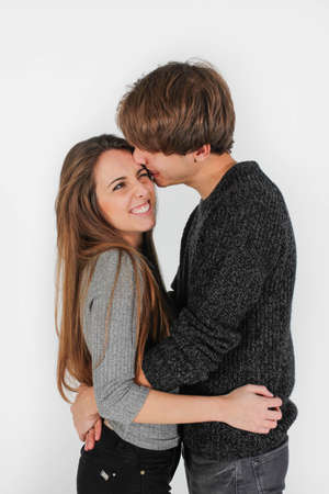 beautiful young couple cuddling, kissing and having funの写真素材