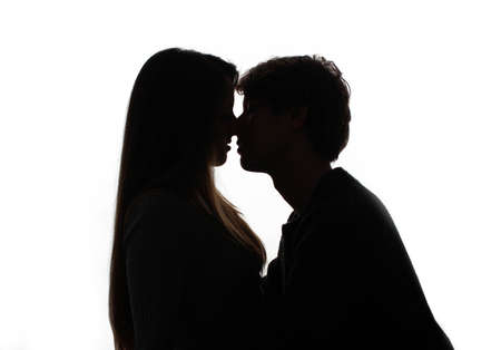 silhouette of kissing heterosexual couple white background