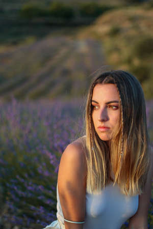 Portrait of pretty young woman posing in lavander fieldsの写真素材