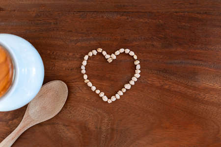 Heart-shaped chickpeas on wooden background for valentineの写真素材